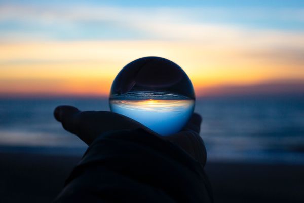 Sunset on a beach refracted through a glass ball