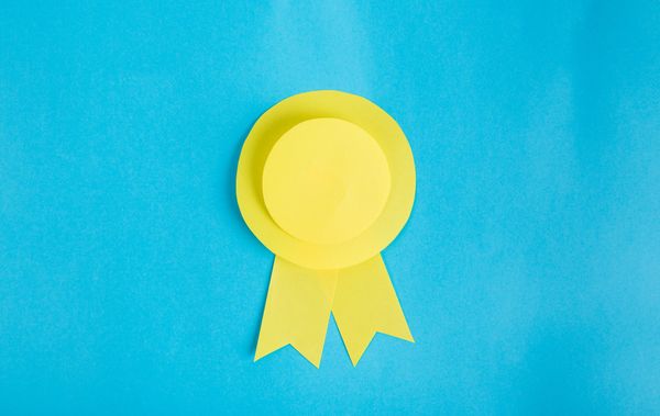 A yellow rosette on a blue background