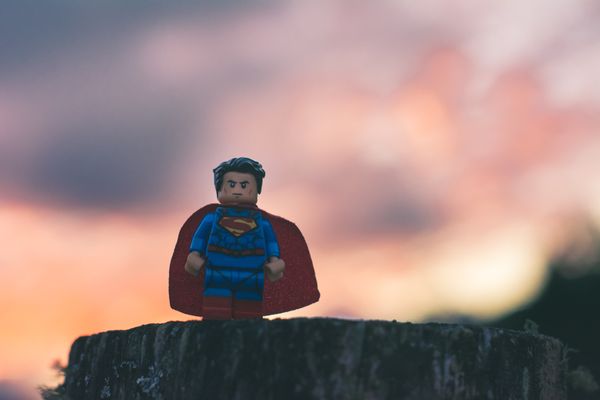 Lego Superman on posed with a dramatic sky behind